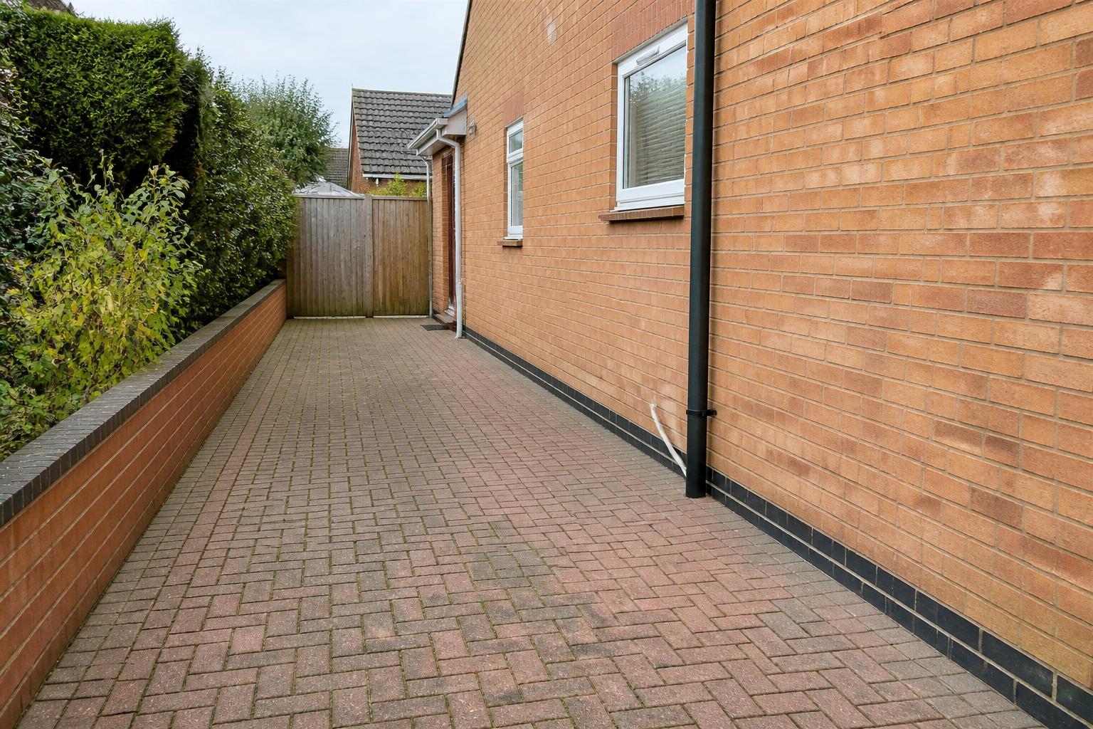 Brick-paved side access completely clear and tidy after collection